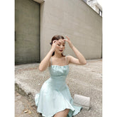 Silk mini dress with pleated hem and adjustable spaghetti straps for elegant summer styling